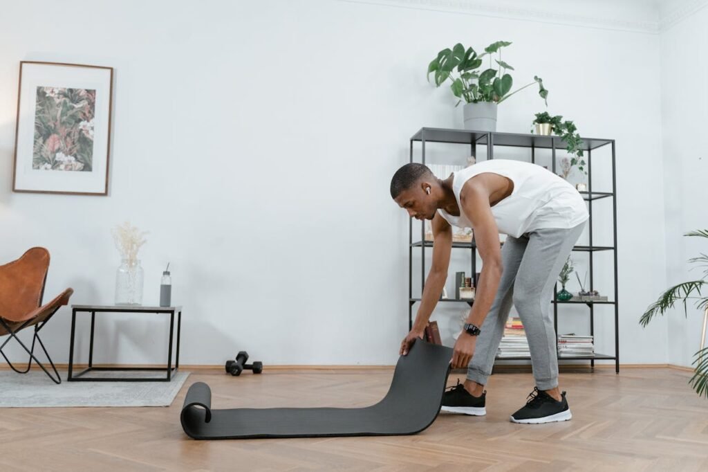 A Man Holding an Exercise Mat 